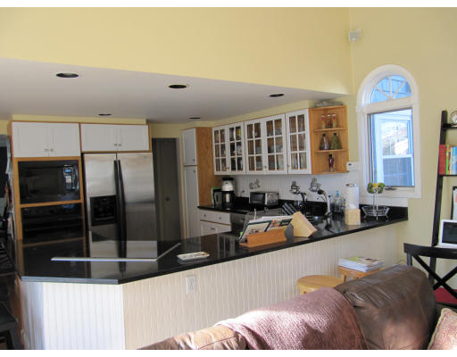40 Pond Street Needham, MA 02492 - Photo 5 of 17 a large kitchen with stainless steel appliances a large counter top a stove and a refrigerator