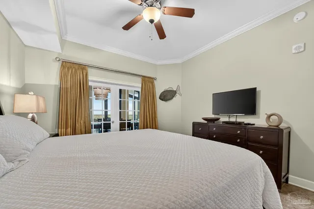 a bedroom with a large bed and a flat tv screen on dresser