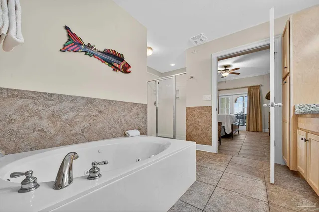 a bathroom with a tub shower and a sink