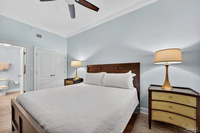a bedroom with a bed and a flat screen tv on the dresser