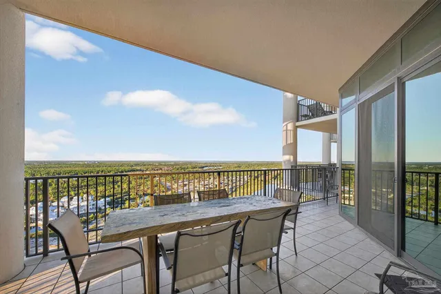 a living room with furniture a flat screen tv and a large window