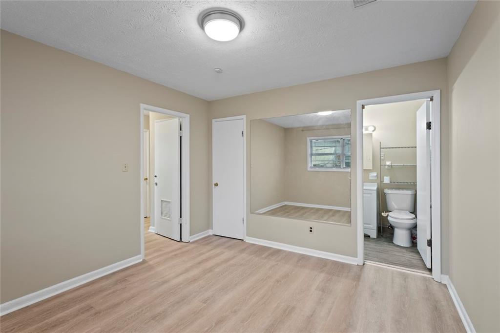 1201 Shoreham Drive Atlanta, GA 30349 - Photo 12 of 21 a bathroom with a sink and mirror