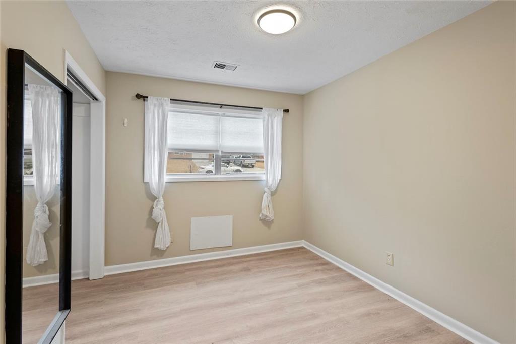 1201 Shoreham Drive Atlanta, GA 30349 - Photo 14 of 21 a view of empty room with wooden floor