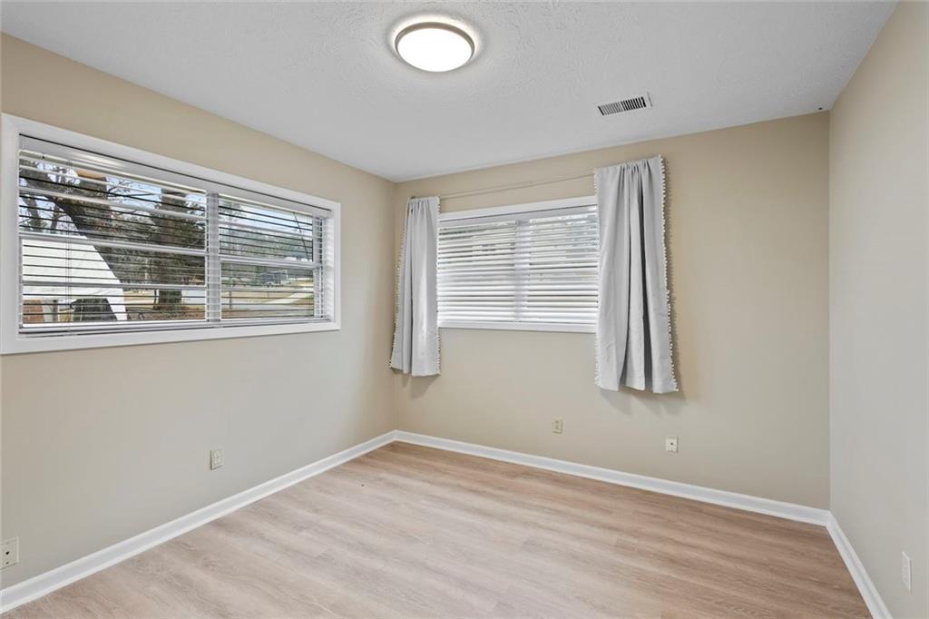 1201 Shoreham Drive Atlanta, GA 30349 - Photo 15 of 21 a view of empty room with wooden floor and fan