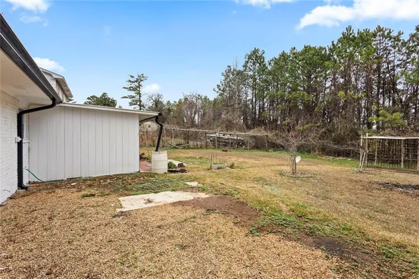 a backyard of a house with table and chairs