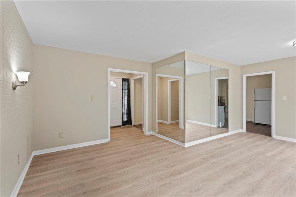 1201 Shoreham Drive Atlanta, GA 30349 - Photo 4 of 21 a view of a livingroom with wooden floor and window
