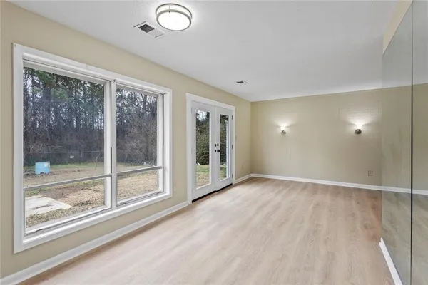 a view of an empty room with glass door