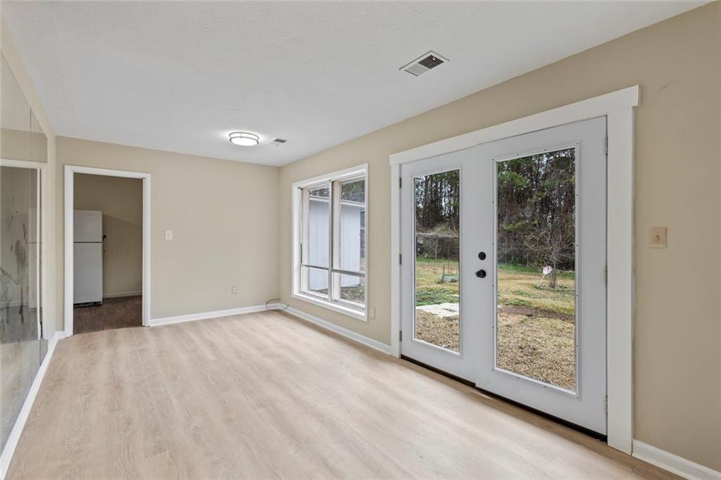 1201 Shoreham Drive Atlanta, GA 30349 - Photo 6 of 21 wooden floor in an empty room with a window