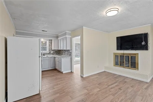 a kitchen with a refrigerator and a stove top oven