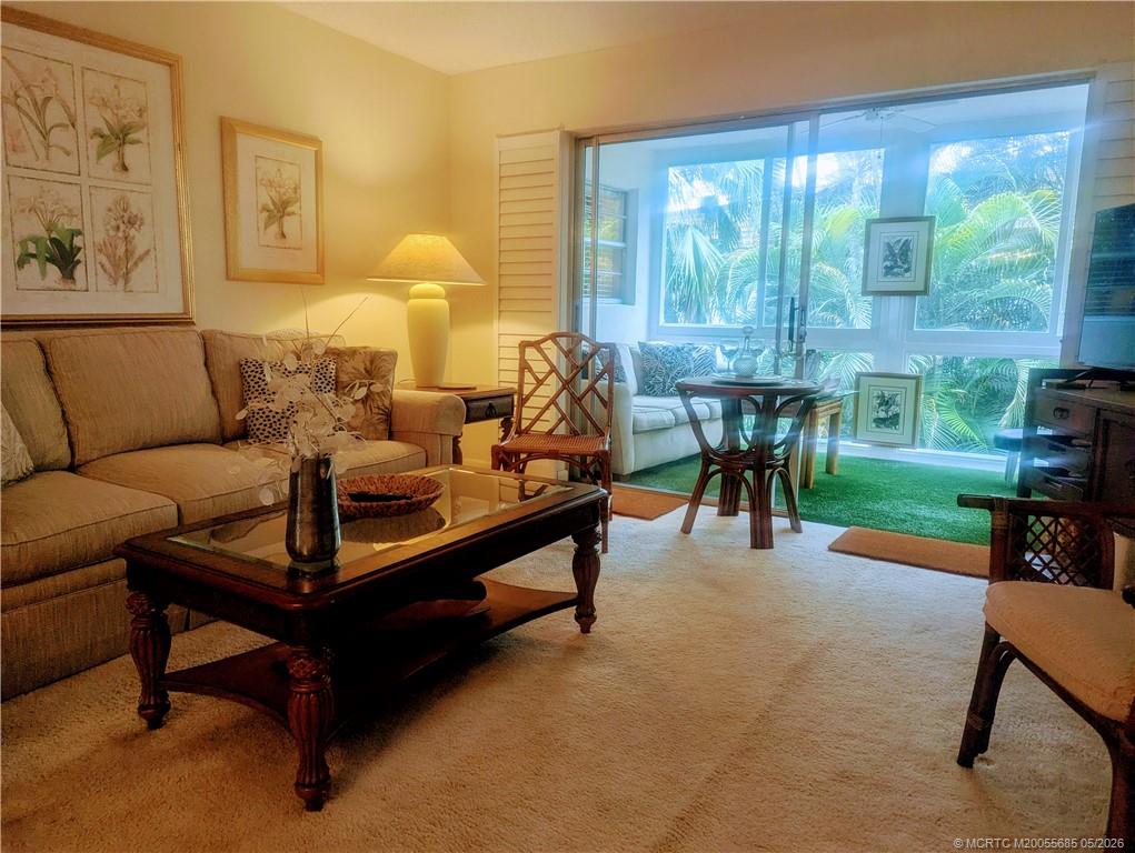2950 Southeast Ocean Boulevard, Unit 56 Stuart, FL 34996 - Photo 4 of 12 a living room with furniture and a large window