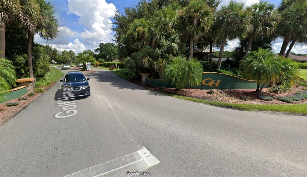 3401 Divot Road Sebring, FL 33872 - Photo 14 of 34 a backyard of a house with table and chairs plants and large trees