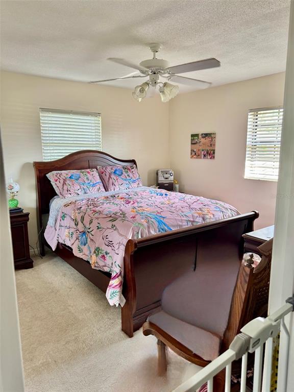 3401 Divot Road Sebring, FL 33872 - Photo 2 of 34 a bedroom with a bed and a chandelier