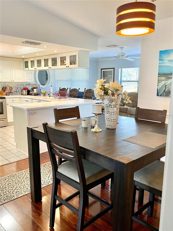 3401 Divot Road Sebring, FL 33872 - Photo 30 of 34 a dining room with furniture and wooden floor