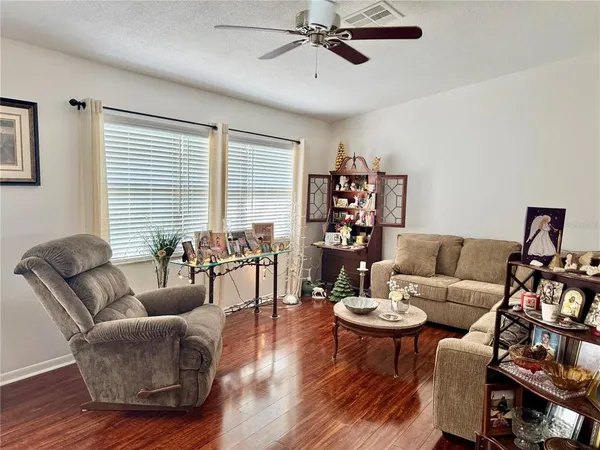 a living room with furniture and a wooden floor