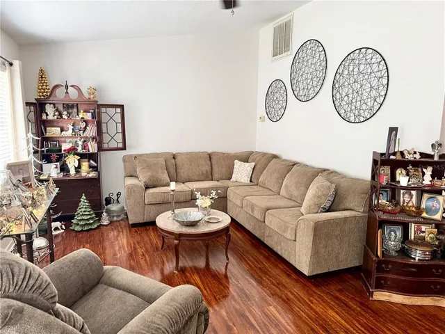a living room with furniture a rug and wall