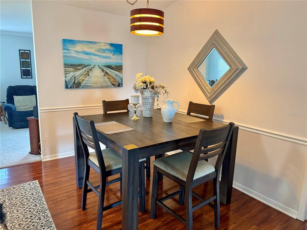 3401 Divot Road Sebring, FL 33872 - Photo 8 of 34 a view of a dining room with furniture and wooden floor