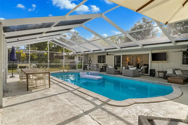 a swimming pool with outdoor seating and yard