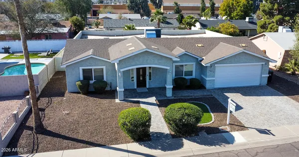 an aerial view of a house with swimming pool and outdoor seating