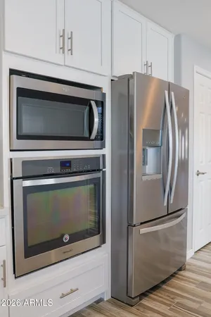 a kitchen with cabinets and stainless steel appliances