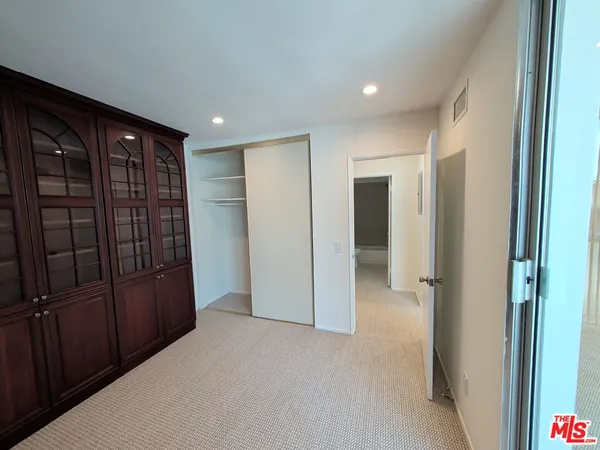 a view of an empty room with closet area