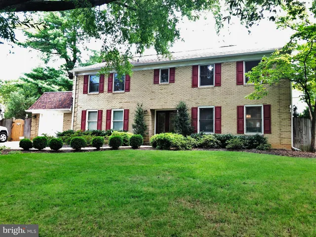 a view of a brick house with a yard