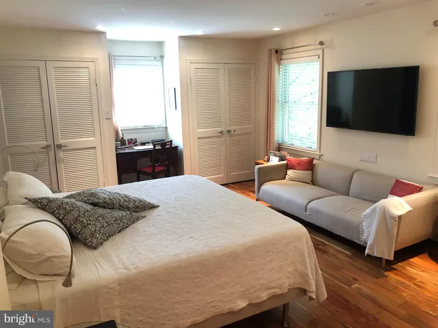 a bedroom with a bed and a flat screen tv