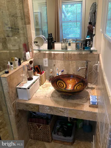 a room with granite countertop a sink a stove and a wooden floor