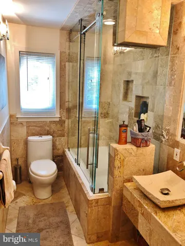 a view of a bathroom with a sink and a mirror