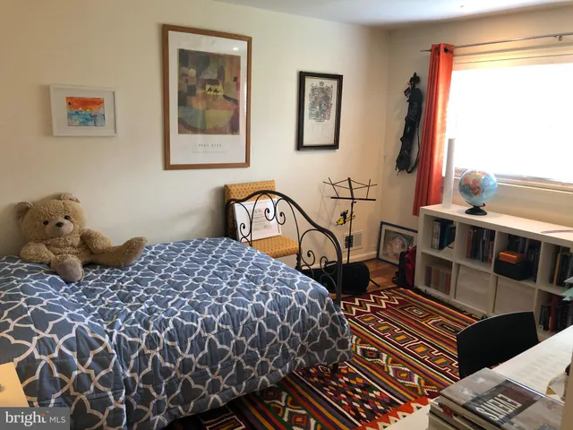 a bed sitting in a bedroom next to a window