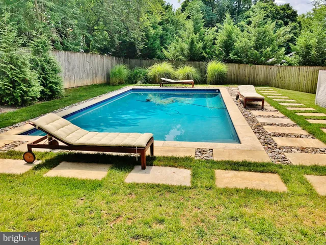 a view of a backyard with sitting area