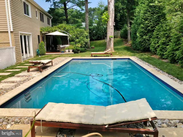 a house with swimming pool in front of it
