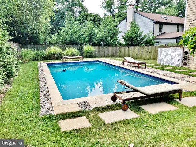a view of a house with a yard and a garden
