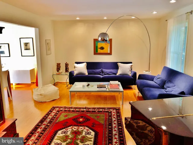 a living room with a couch and a potted plant