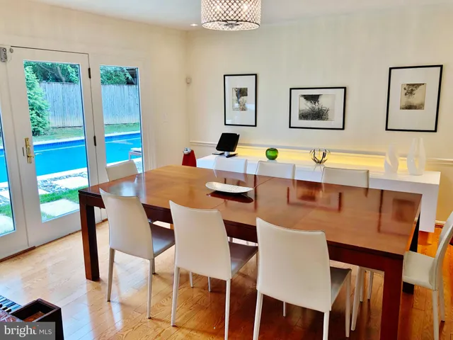 a view of a dining room with furniture and a large window