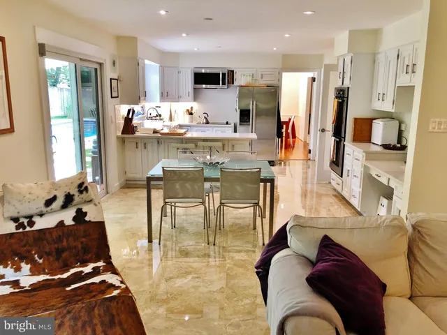 a living room with stainless steel appliances kitchen island granite countertop furniture and a kitchen view