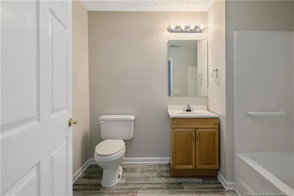 a bathroom with a bath tub and a sink
