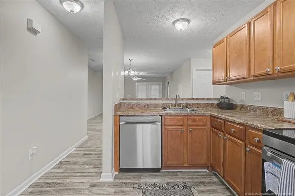 a kitchen with a sink cabinets and window