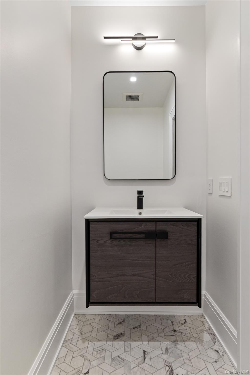 42 Mamaroneck Road Scarsdale, NY 10583 - Photo 42 of 47 A beautifully finished powder room adds convenience for guests enjoying the home's lower-level amenities.
