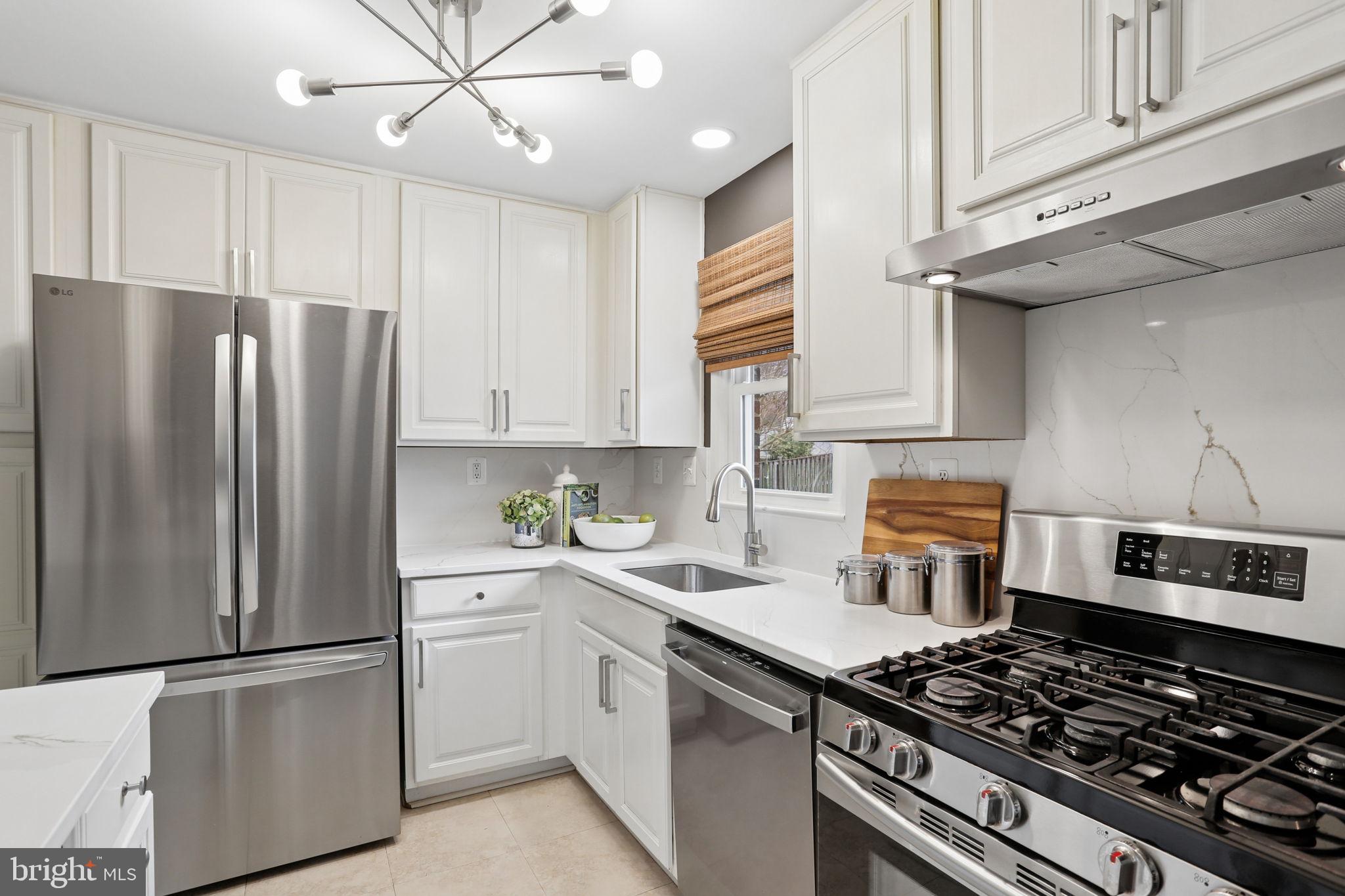 5909 Ridge View Drive Alexandria, VA 22310 - Photo 11 of 35 a kitchen with stainless steel appliances a refrigerator sink and cabinets