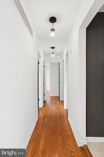 a view of a hallway with wooden floor