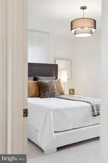 a bedroom with a bed and a lamp