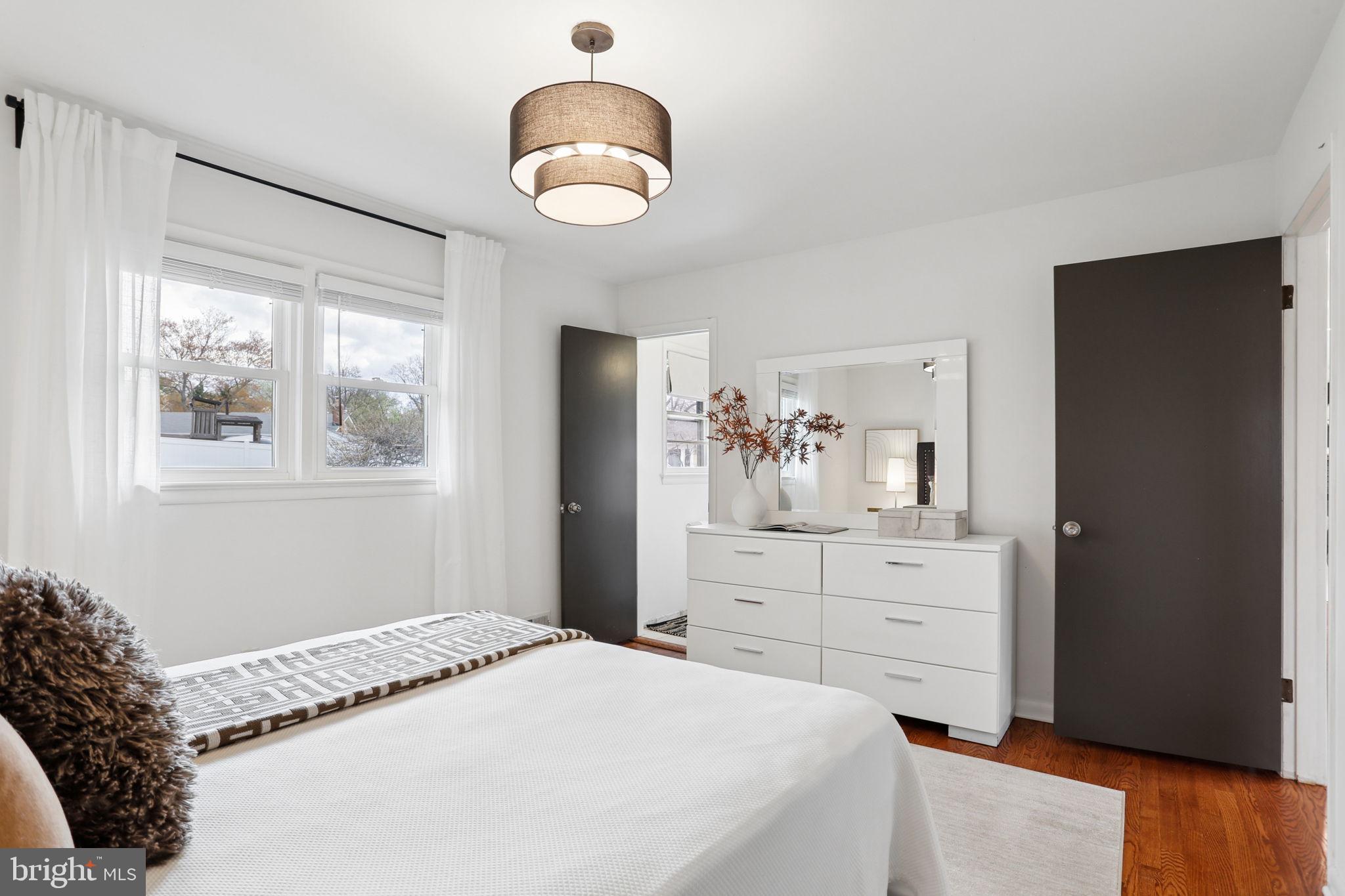 5909 Ridge View Drive Alexandria, VA 22310 - Photo 17 of 35 a bedroom with a bed and a chandelier