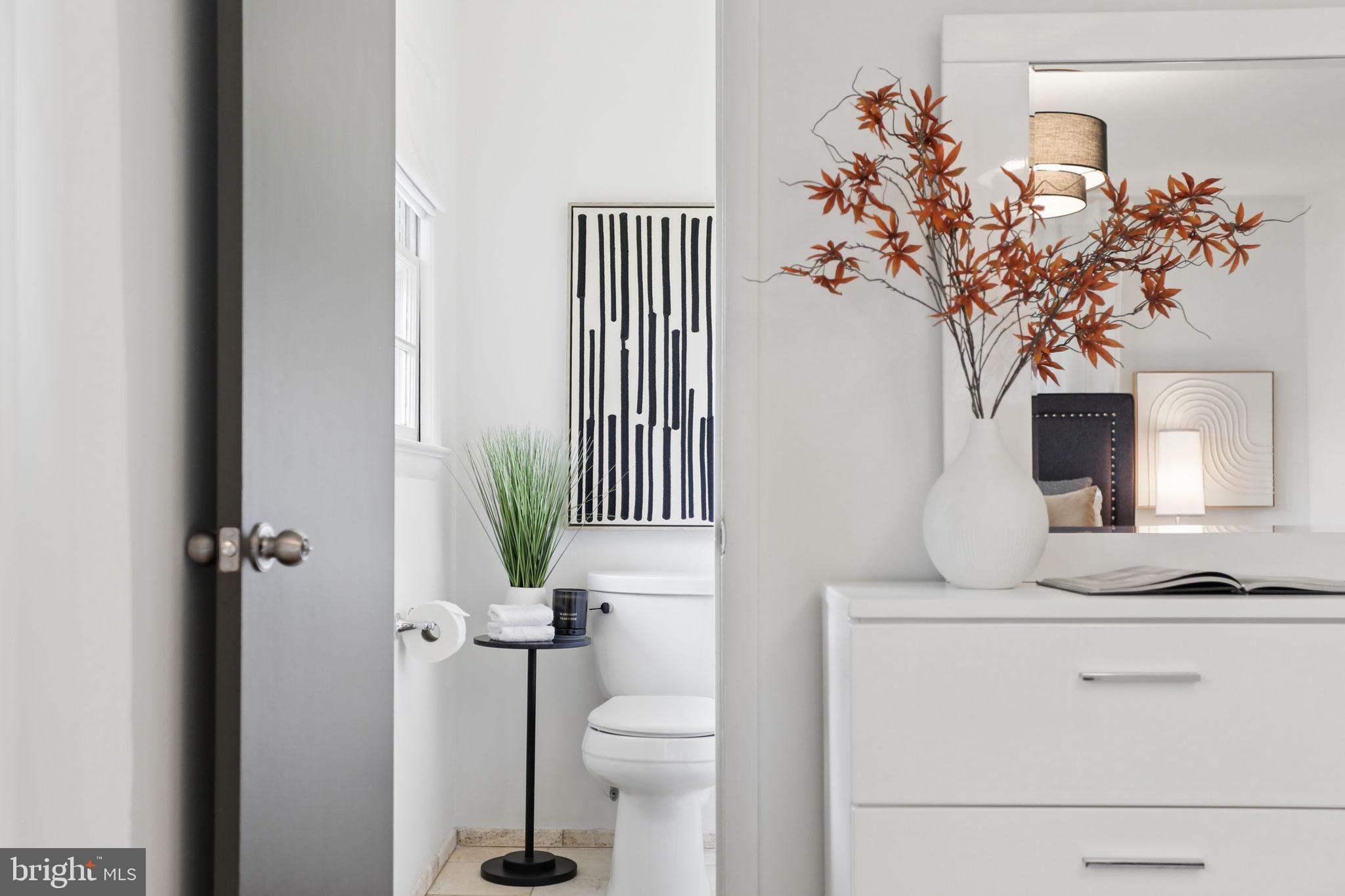 5909 Ridge View Drive Alexandria, VA 22310 - Photo 18 of 35 a bathroom with a toilet sink and mirror