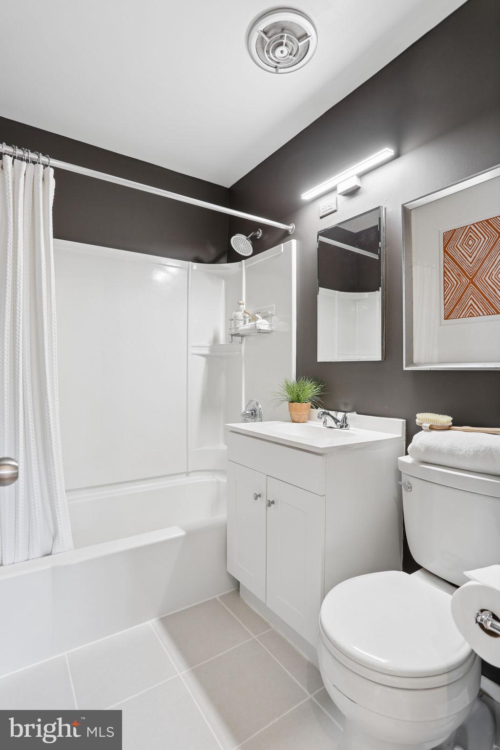 5909 Ridge View Drive Alexandria, VA 22310 - Photo 22 of 35 a bathroom with a granite countertop sink toilet and shower