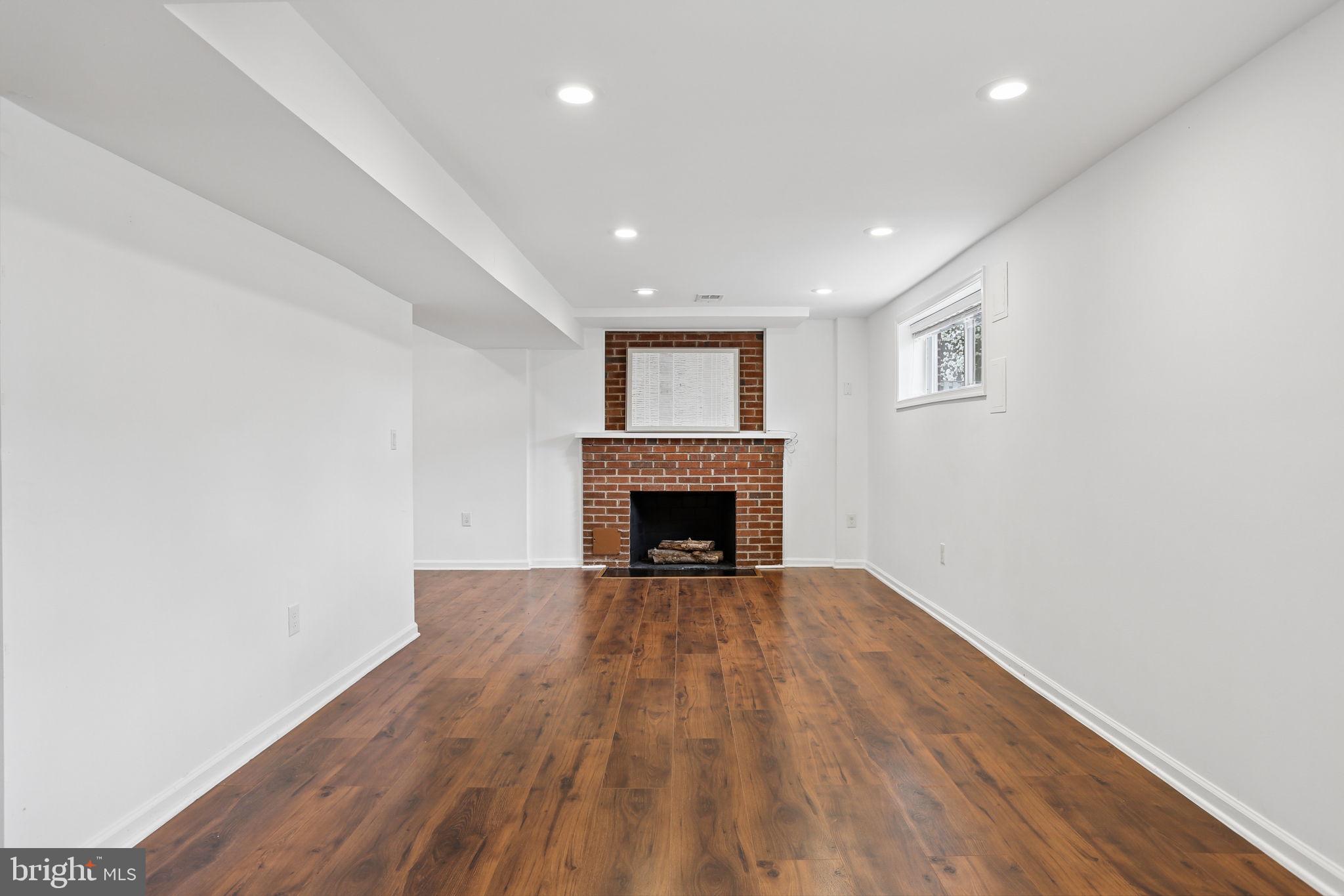 5909 Ridge View Drive Alexandria, VA 22310 - Photo 24 of 35 a view of an empty room with wooden floor fireplace and a window