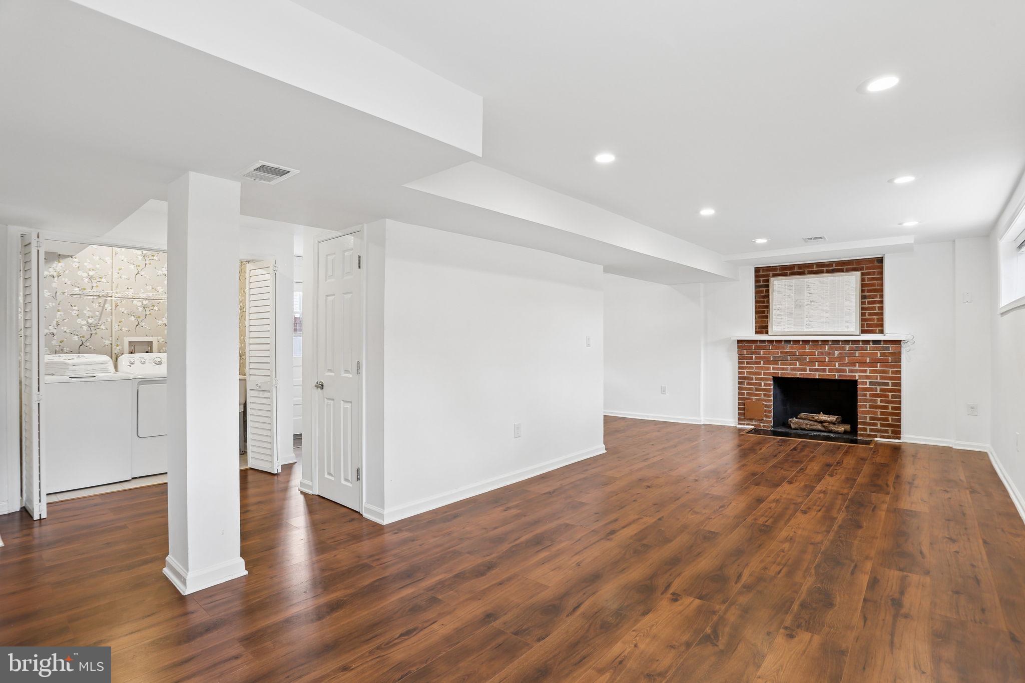 5909 Ridge View Drive Alexandria, VA 22310 - Photo 26 of 35 a view of an empty room with wooden floor and a fireplace