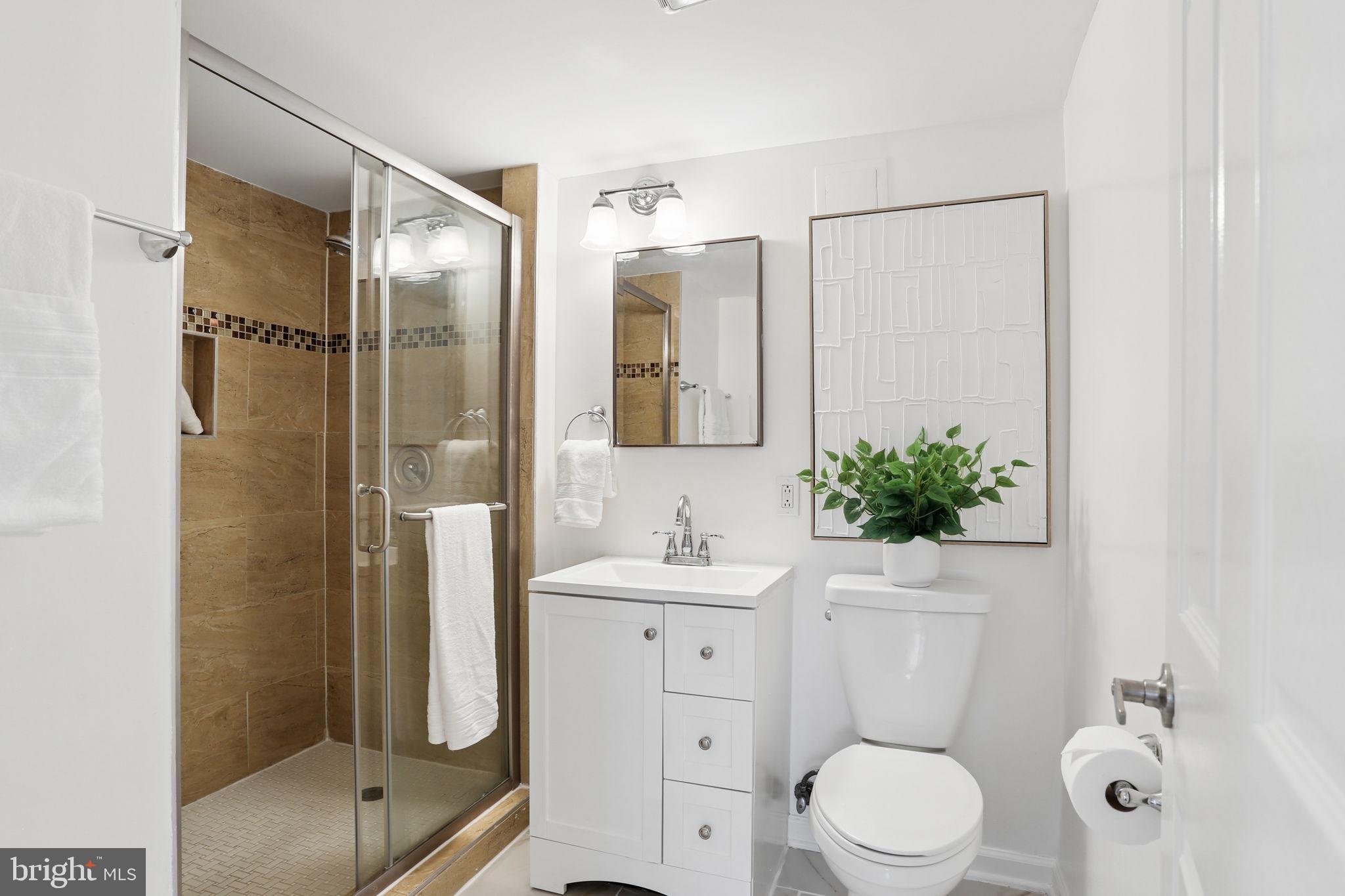 5909 Ridge View Drive Alexandria, VA 22310 - Photo 29 of 35 a bathroom with a sink toilet and shower