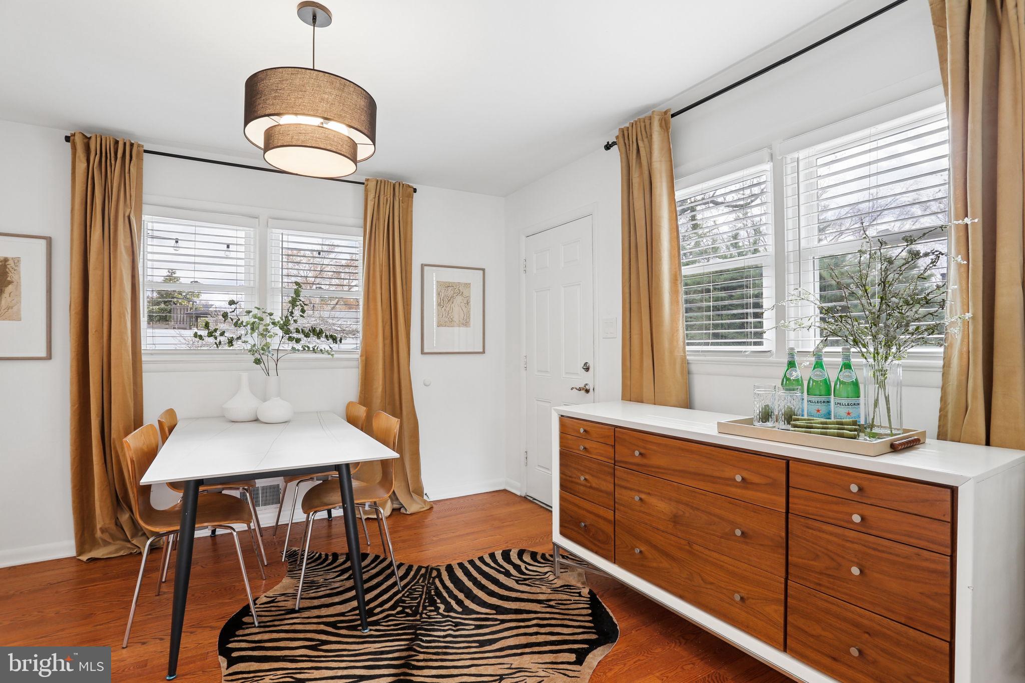 5909 Ridge View Drive Alexandria, VA 22310 - Photo 7 of 35 a dining room with wooden floor and a chandelier