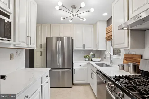 a kitchen with a stove a sink and a refrigerator