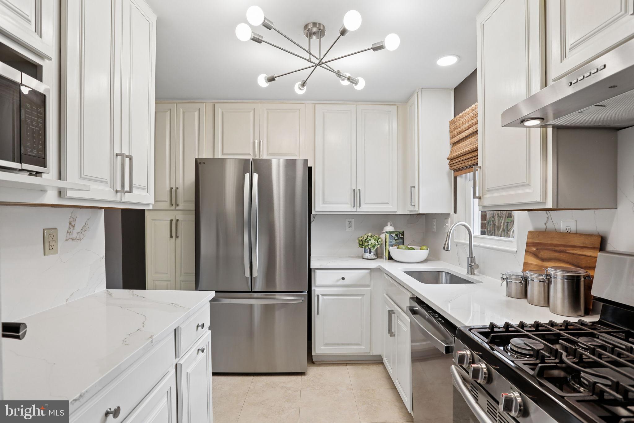 5909 Ridge View Drive Alexandria, VA 22310 - Photo 10 of 35 a kitchen with a stove a sink and a refrigerator